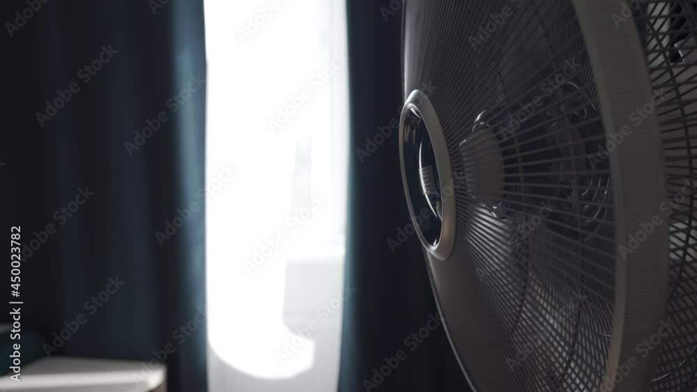 Electrical cooling floor fan works in modern apartment on summer day closeup. High quality 4k footage Electrical cooling floor fan works in modern apartment on summer day closeup. High quality 4k footage