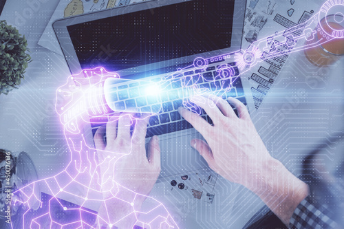 Double exposure of man's hands typing over computer keyboard and virtual reality hologram drawing. Top view. Technology concept. Future.