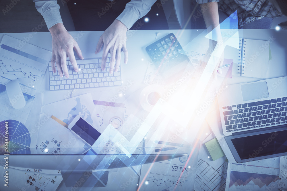 Double exposure of man and woman working together and arrows drawing. Computer background. Top View. Growth concept. Double exposure of man and woman working together and arrows drawing. Computer background. Top View. Growth concept.