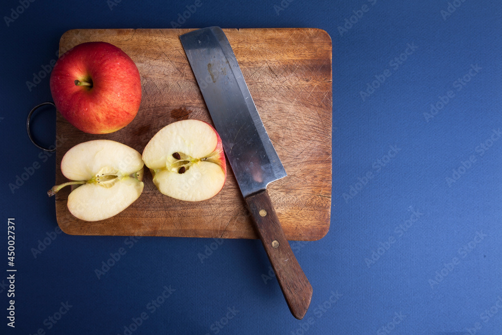 Apples on cutting board with knife