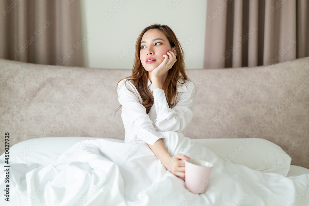 portrait beautiful woman wake up and holding coffee cup or mug on bed portrait beautiful woman wake up and holding coffee cup or mug on bed