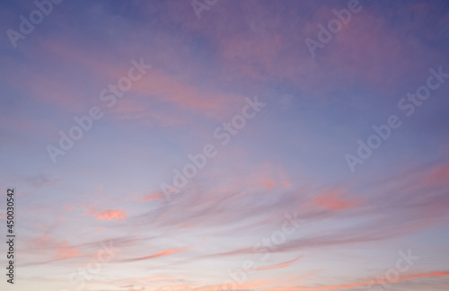 Scenery. Photo of the evening sky. Crimson yellow clouds against a blue sky at sunset before a thunderstorm. © Trik