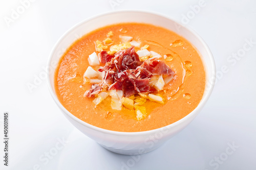 High angle view of a bowl of salmorejo soup on white background photo