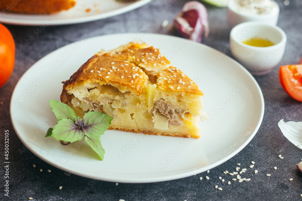 Chicken and potato pie. Tasty pie. Pie and vegetables on the table Chicken and potato pie. Tasty pie. Pie and vegetables on the table