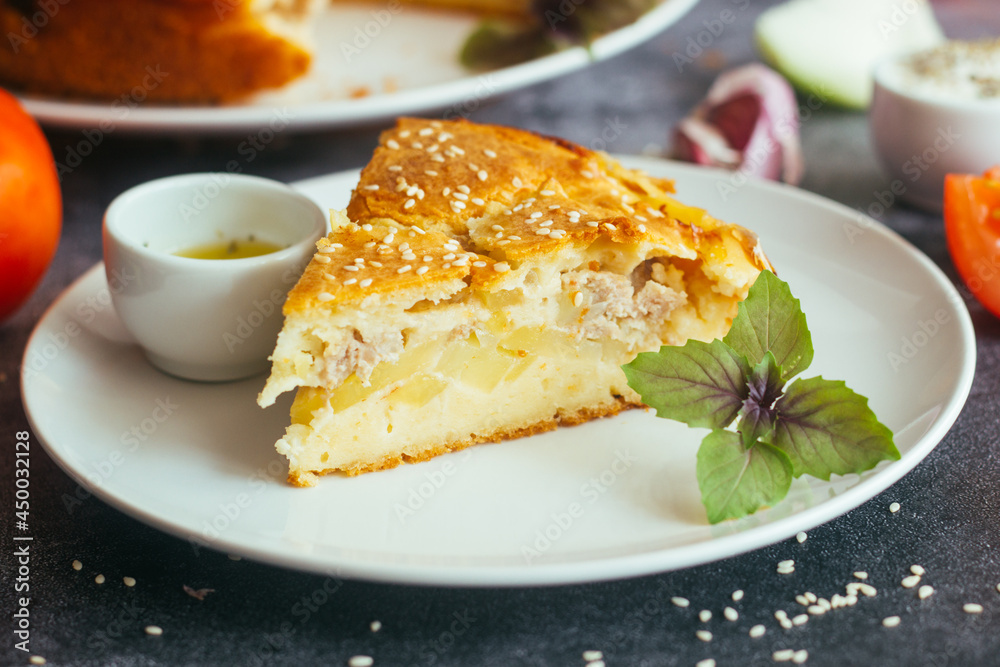 Chicken and potato pie. Tasty pie. Pie and vegetables on the table Chicken and potato pie. Tasty pie. Pie and vegetables on the table