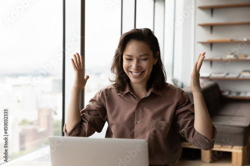 Excited happy business woman celebrating win, success, achieve, high result at laptop, getting job promotion, good news, reward, winning prize, looking at screen, making winner gesture