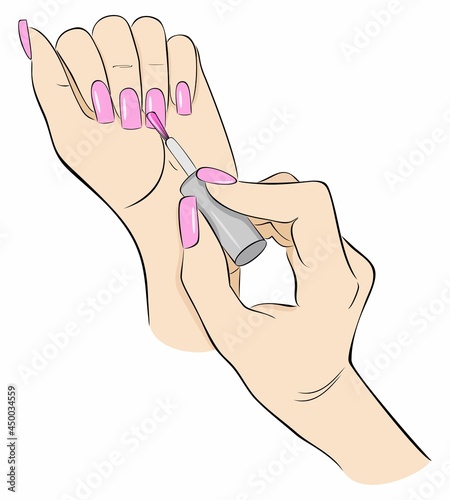 Manicure. Woman paints her nails with a brush from a bottle of varnish