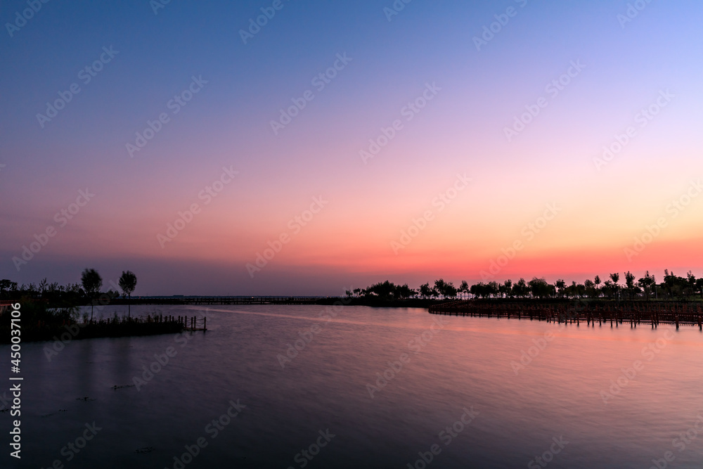 Lake and natural scenery in the park at sunset in summer, Asia