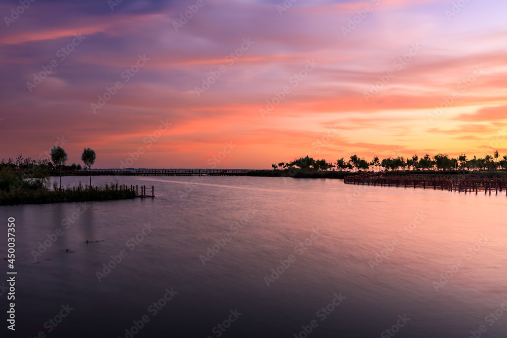 Lake and natural scenery in the park at sunset in summer, Asia