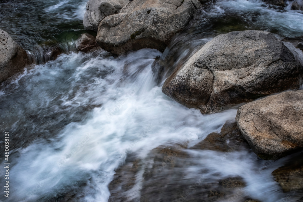 detail of a mountain river flowing between rocks, long exposure silk effect detail of a mountain river flowing between rocks, long exposure silk effect