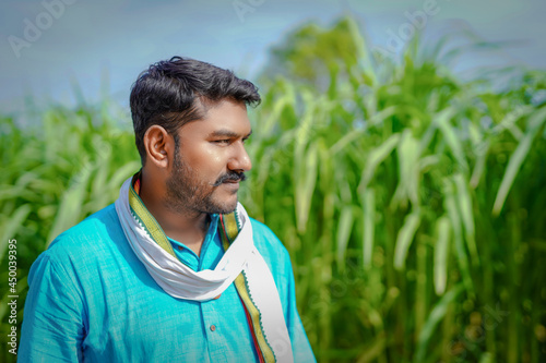 indian farmer at sugarcane field