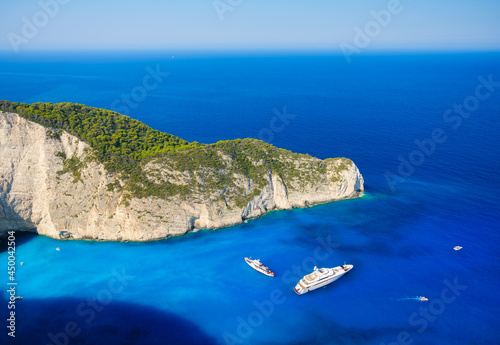 Aerial view on yacht in the bay. Rocks and bright turquoise sea water. Azure ...