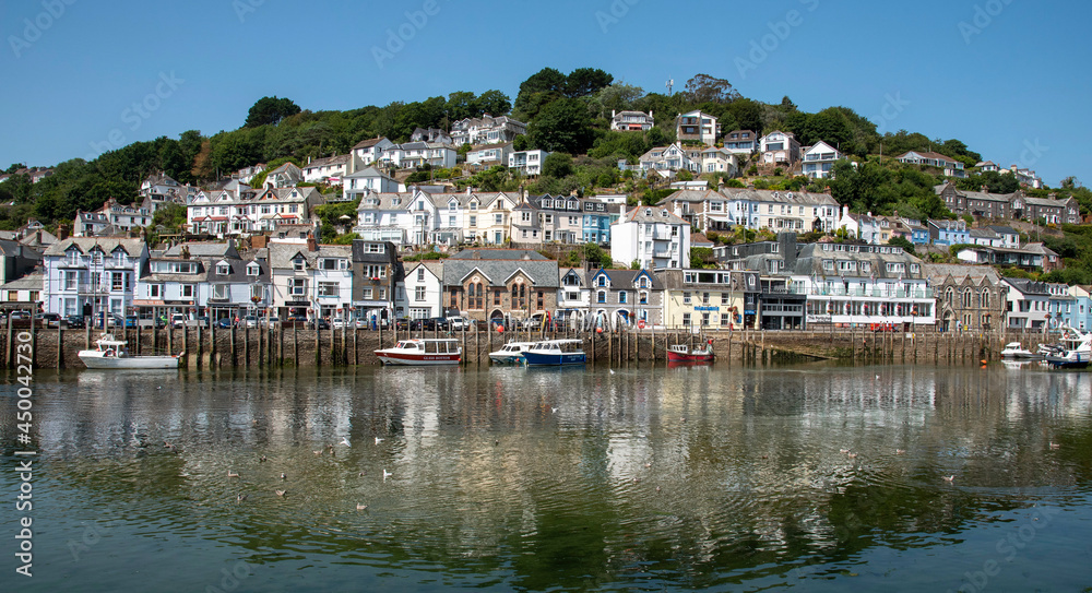 West Looe, Cornwall, England, UK. Properties reflected in the Looe River on  an incoming tide at West Looe a popular holiday resort.