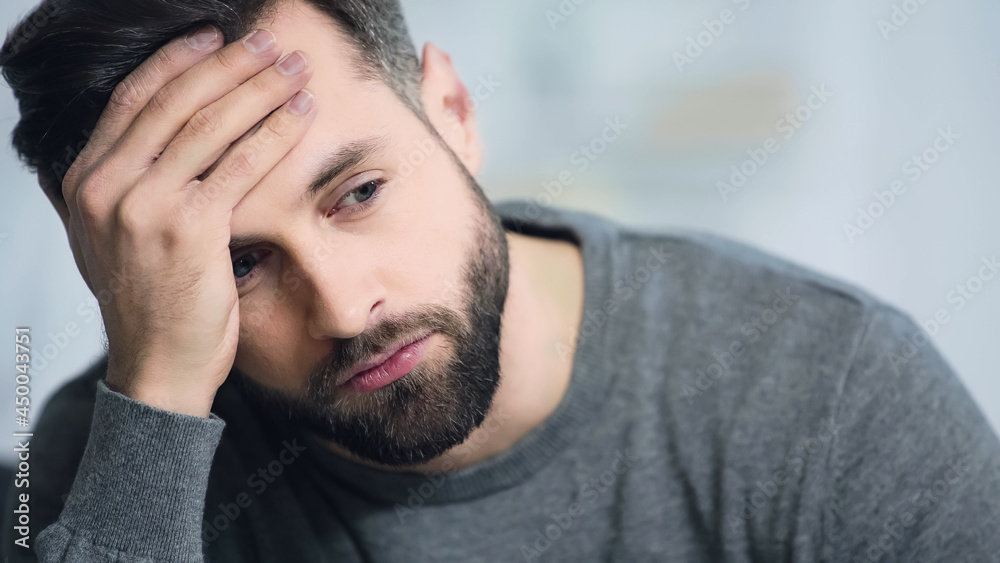 dissatisfied and bearded man touching forehead and looking away dissatisfied and bearded man touching forehead and looking away