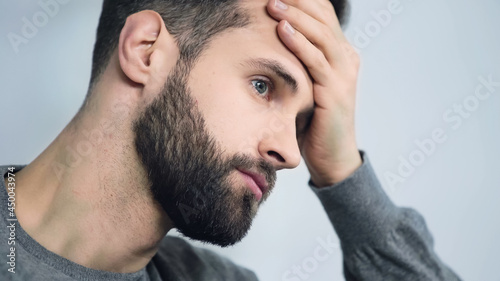 frustrated man touching forehead with hand