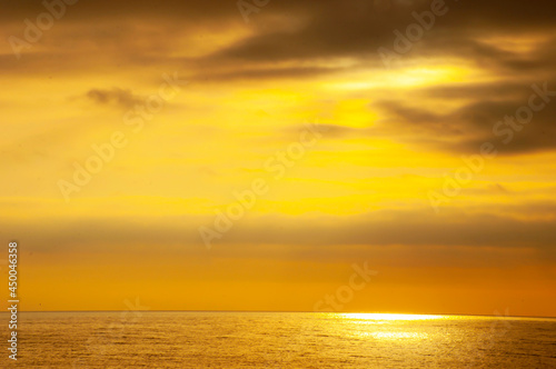 Bright beautiful sunrise or sunset on the sea. The concept of a seascape and meditation on the background of a colorful sky and sea.