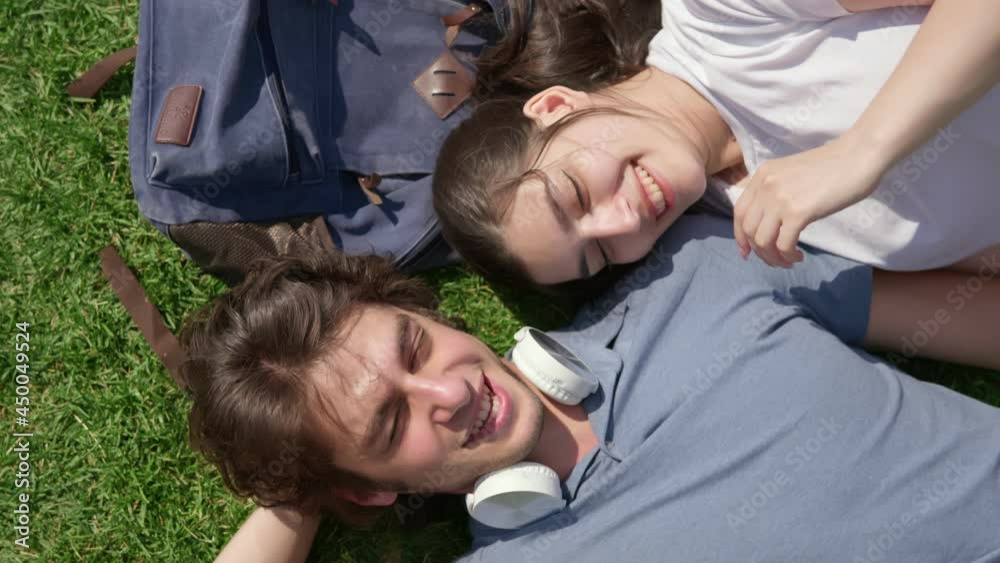 Top view of romantic young couple resting on grass in park Top view of romantic young couple resting on grass in park