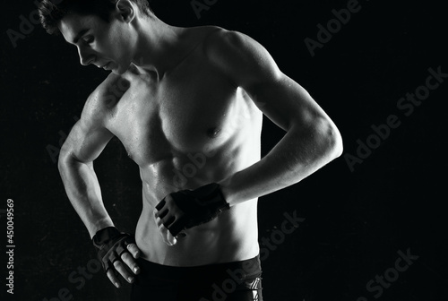 man with a pumped-up torso workout exercise sport dark background