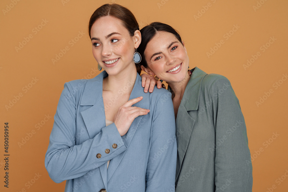 Two smiling elegant women wearing smart jackets Two smiling elegant women wearing smart jackets