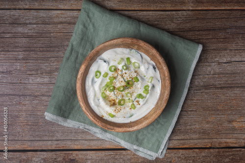 Traditional Indian Raita with Dahi in a bowl on a wooden background