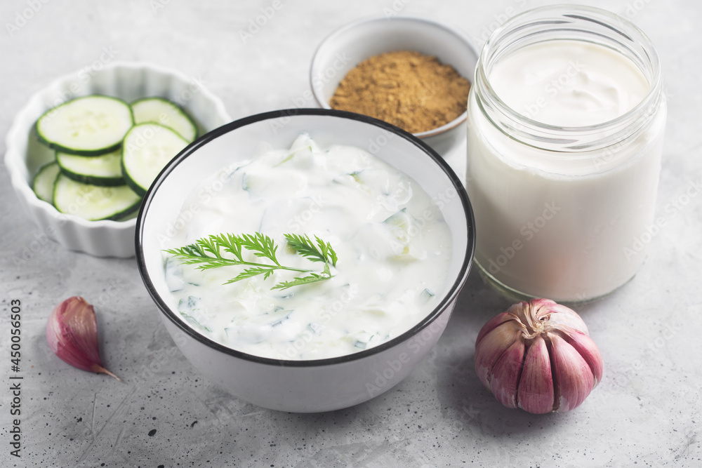 Traditional Indian Raita with Dahi in a bowl with dill Traditional Indian Raita with Dahi in a bowl with dill