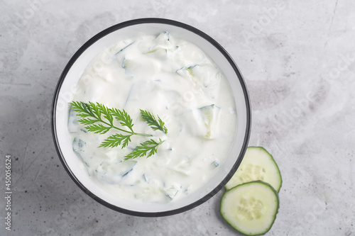 Traditional Indian Raita with Dahi in a bowl with spices photo