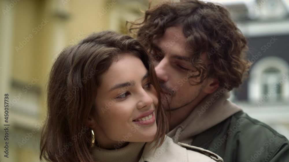 Affectionate couple hugging in city center. Guy and girl dating on urban street. Affectionate couple hugging in city center. Guy and girl dating on urban street.