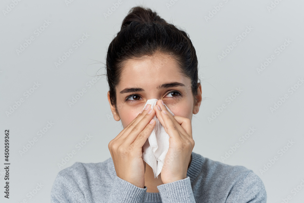 woman in gray sweater runny nose health problems infection woman in gray sweater runny nose health problems infection