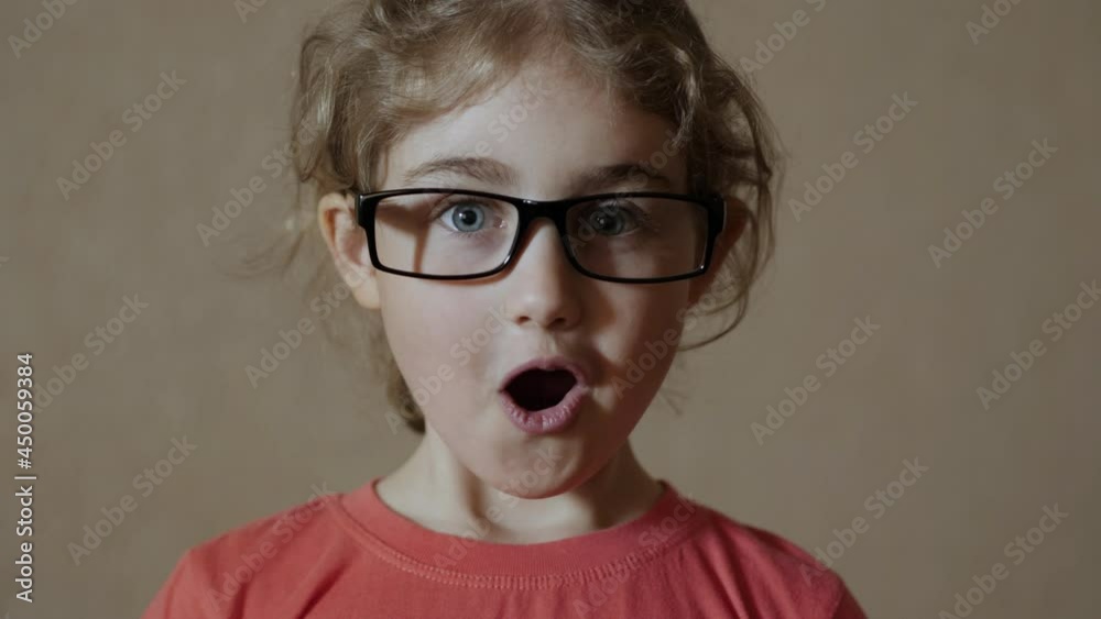 Girl Looks Surprised Happy to Receive Surprise Gift. Portrait Little Girl Looking at Camera. Christmas New Year Birthday Present. Astonished Child Looks Into Camera With Delight Surprise at Face. Girl Looks Surprised Happy to Receive Surprise Gift. Portrait Little Girl Looking at Camera. Christmas New Year Birthday Present. Astonished Child Looks Into Camera With Delight Surprise at Face.