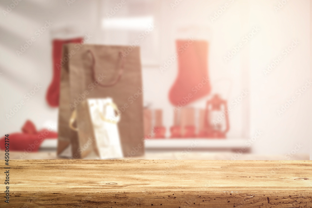 Wooden table in Christmas evening and background with gifts from Santa Claus Wooden table in Christmas evening and background with gifts from Santa Claus