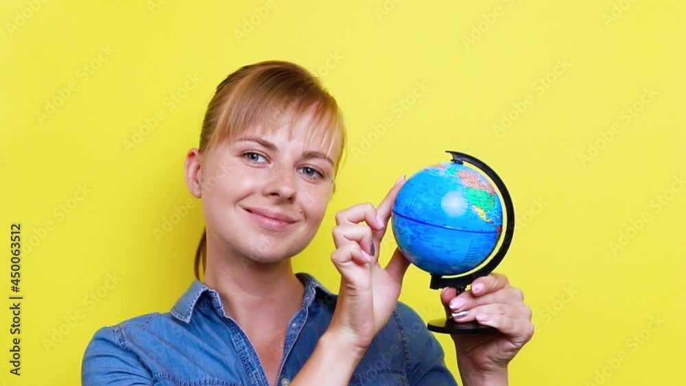 girl scrolls the globe and selects on it girl scrolls the globe and selects on it