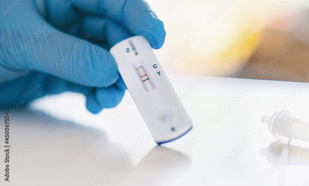 Man using a rapid antigen test kit. Rapid antigen testing is a screening tool to help to detect Corona COVID-19 in people without any symptoms of Sars-CoV-2