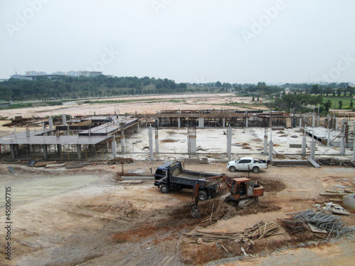 PENANG, MALAYSIA -JUNE 18, 2021: Structural works are underway at the construction site. Construction workers are installing formwork made of metal or timber. Safety features are paramount. 
