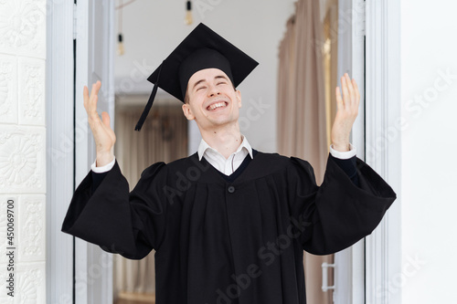 Education, graduation and people concept - happy male student with diploma at home showing his emotions