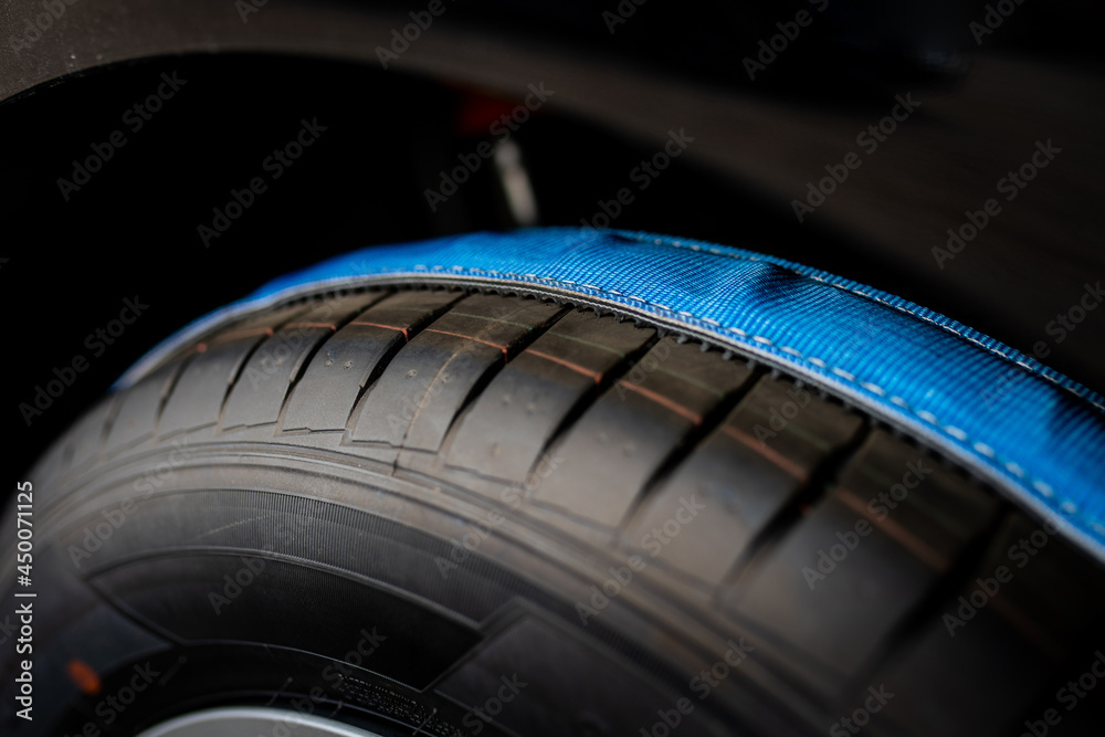 securing the car for transport - logistics - transport belt on the wheel