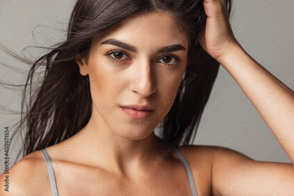 Close-up portrait of young beautiful arabian woman without makeup isolated over gray studio background. Natural beauty concept. Close-up portrait of young beautiful arabian woman without makeup isolated over gray studio background. Natural beauty concept.