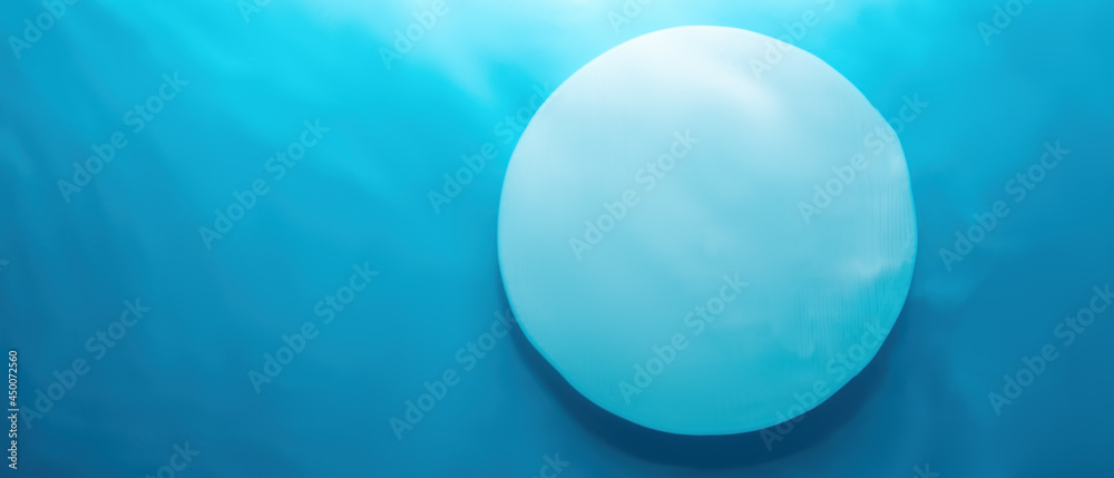 Empty white circle podium on blue water texture with waves in sunlight. layout, copyspace.Abstract background for product presentation. Empty white circle podium on blue water texture with waves in sunlight. layout, copyspace.Abstract background for product presentation.