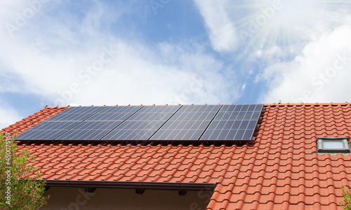 House with solar panels on roof building. Solar panel installed .on the house roof