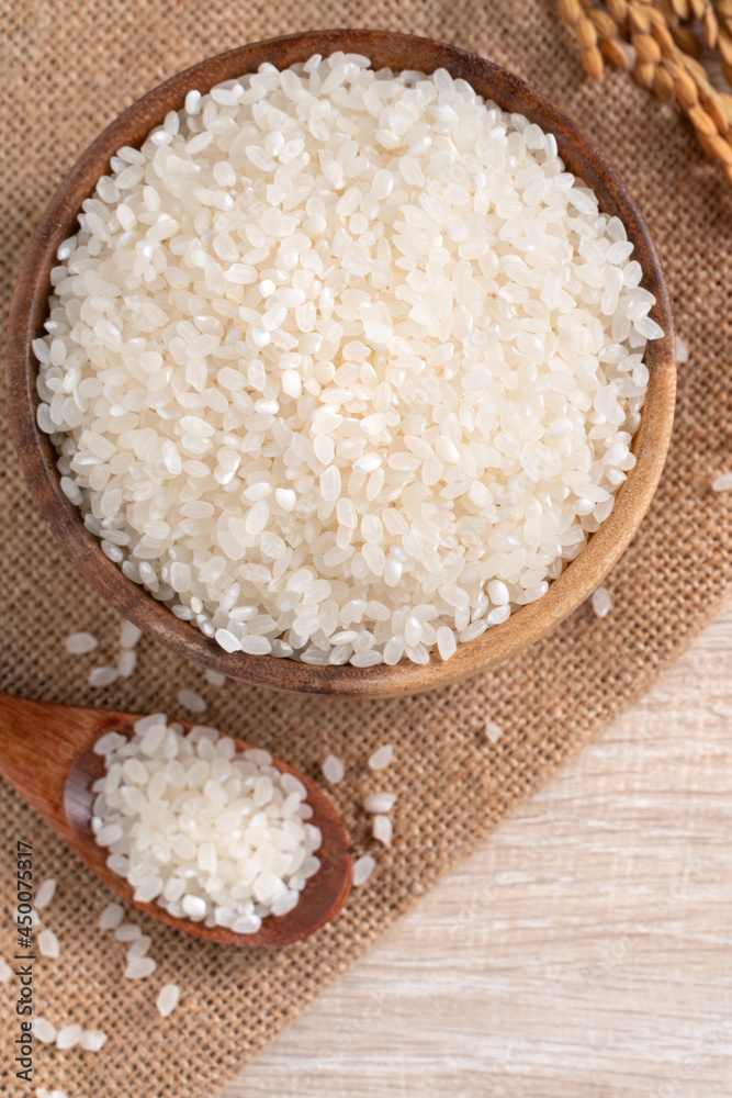 White rice in a bowl on wooden table background. White rice in a bowl on wooden table background.