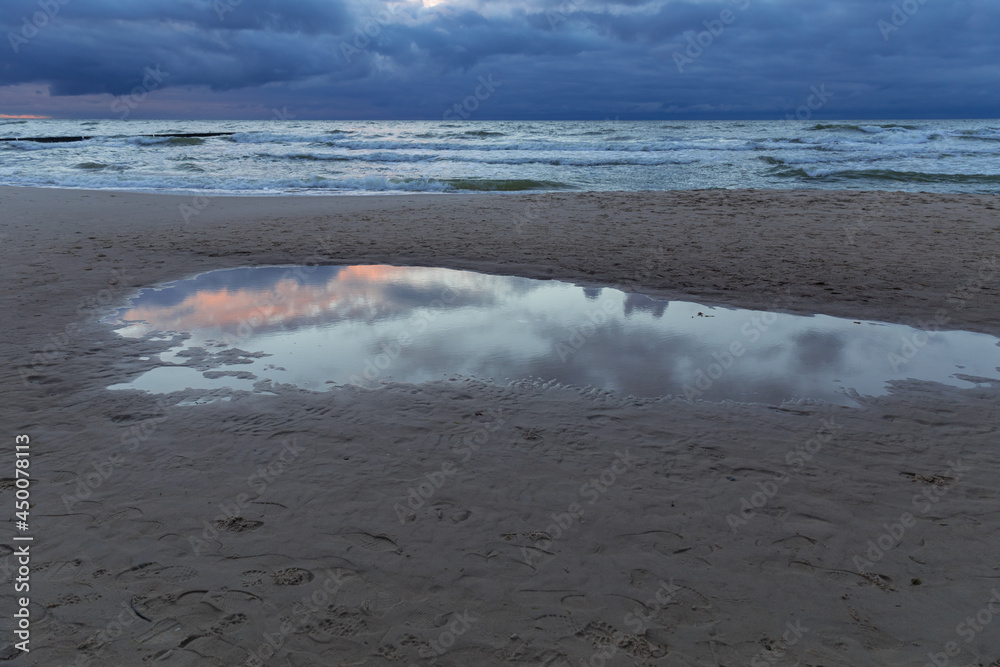 cloudy sunset over the sea, menacing sky and rough waves cloudy sunset over the sea, menacing sky and rough waves