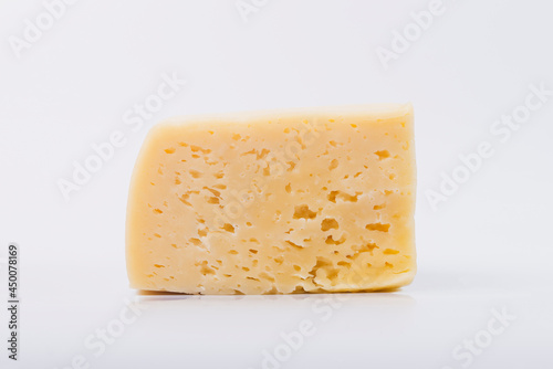 Cheese on a white isolated white background. Cheese texture.