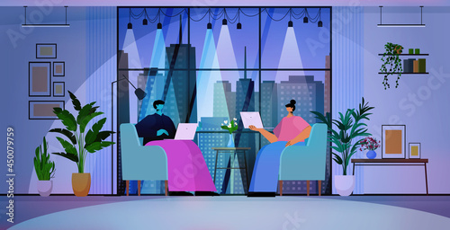 businesspeople using laptops business people working in modern dark night office horizontal
