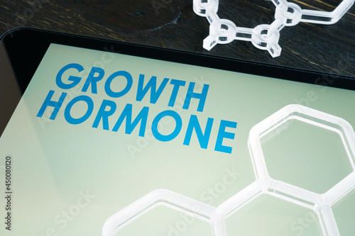 Growth hormone on the tablet screen with chemical symbols. photo