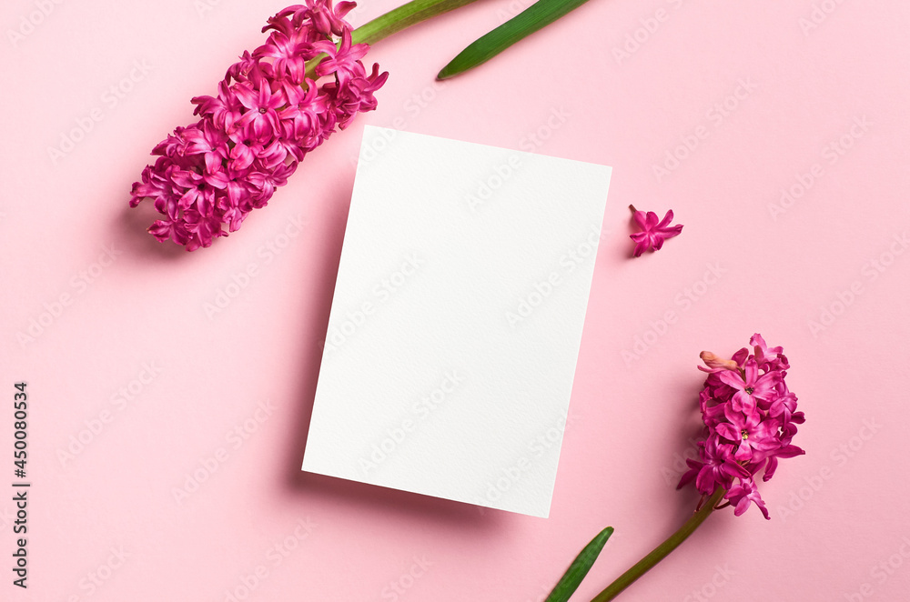 Greeting or invitation card mockup with spring hyacinth flowers on pink paper background Greeting or invitation card mockup with spring hyacinth flowers on pink paper background