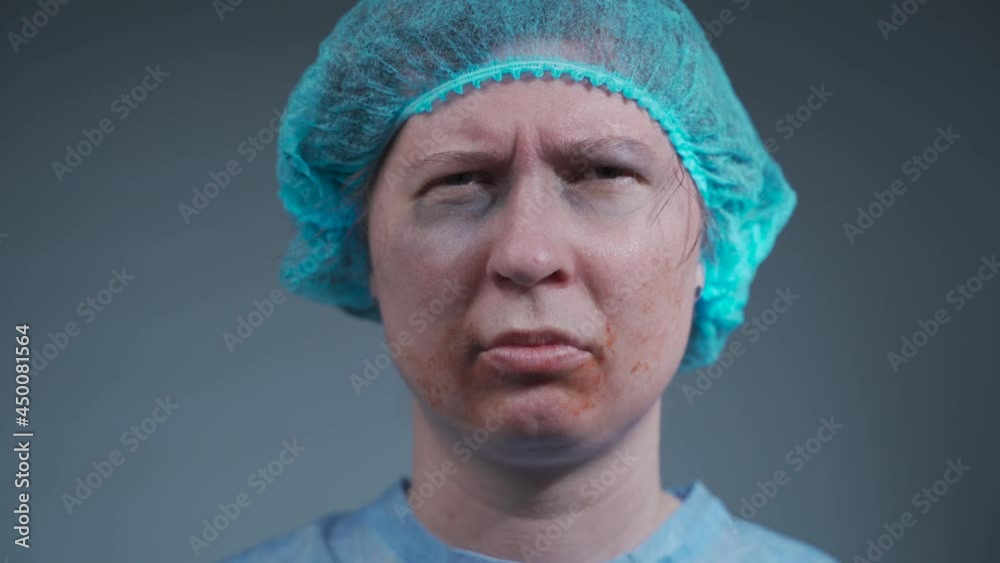 Domestic physical violence, inflicting physical harm on defenseless victim. Portrait woman crying in hospital looking at camera with face and dental injuries. Female in hospital wear after accident. Domestic physical violence, inflicting physical harm on defenseless victim. Portrait woman crying in hospital looking at camera with face and dental injuries. Female in hospital wear after accident.