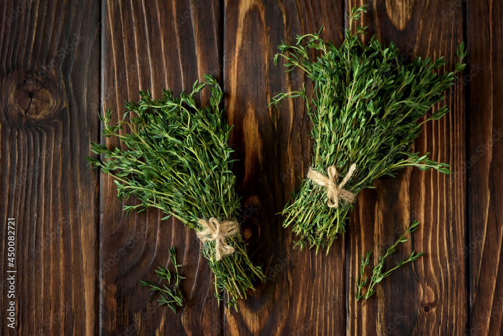 Fresh herb thyme on brown wooden background. Top view Fresh herb thyme on brown wooden background. Top view