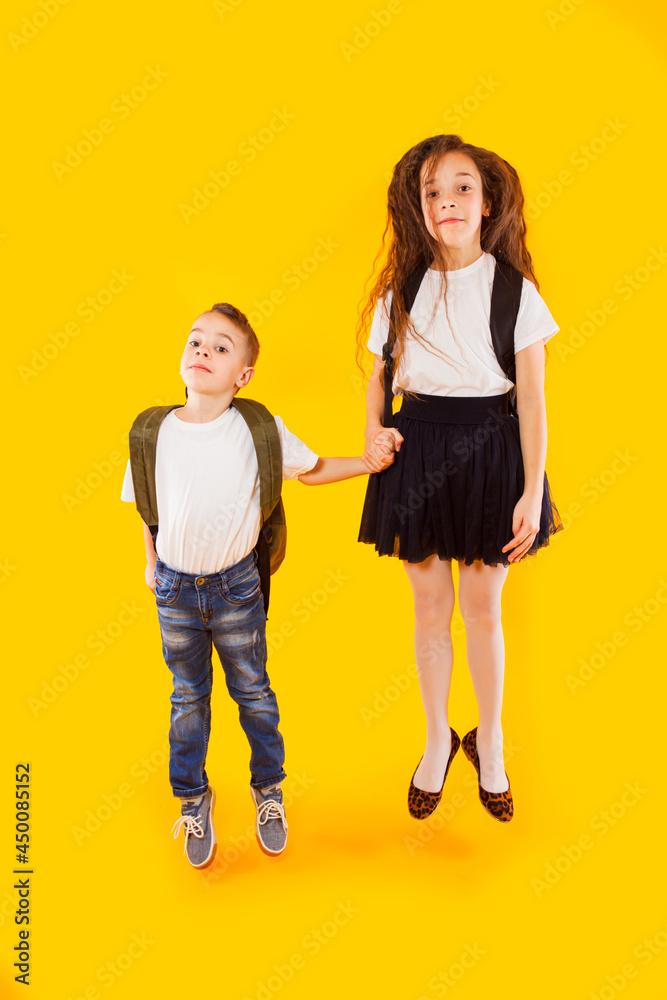 Brother and sister are jumping and holding hands Brother and sister are jumping and holding hands