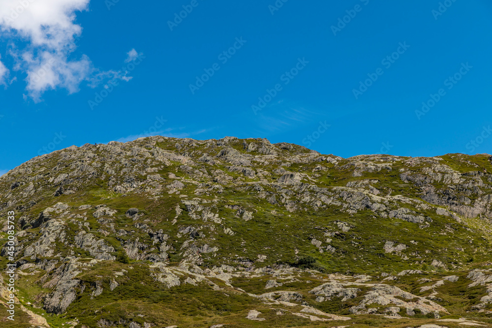Panorama from the Gotthard pass in Ticino of the Swiss Alps on a summer's day with sunshine and blue skies