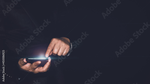 Businessman holding smartphone. Man using phone in office