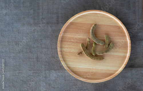 Young tamarind in a wooden tray on the wooden floor